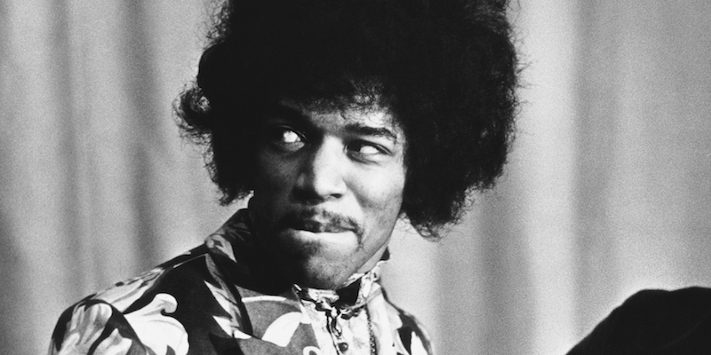 1st October 1967: Influential rock guitarist, singer and songwriter Jimi Hendrix (1942 - 1970) holds an award which he has just received from Radio One DJ Jimmy Savile. (Photo by Express/Express/Getty Images)